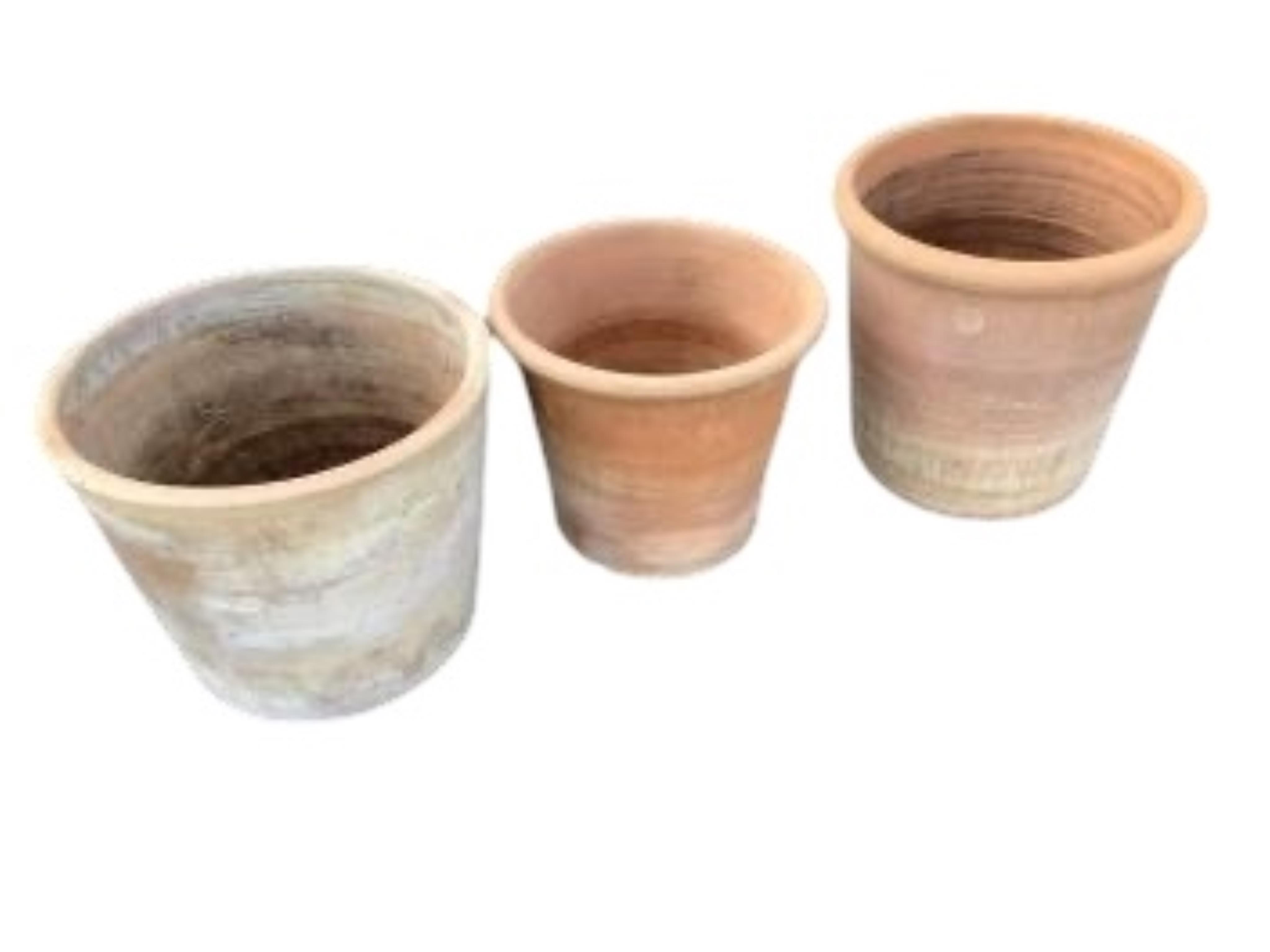 Three circular terracotta garden planters, largest diameter 44cm, height 35cm